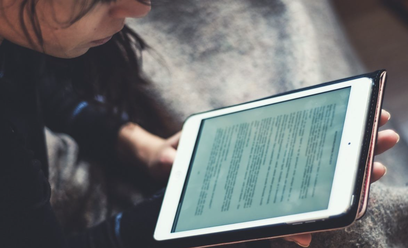 A person holds a tablet to read it